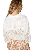 Back view of Vintage Lace Cropped Jacket Top in off white, featuring lace details and ruffled hem.