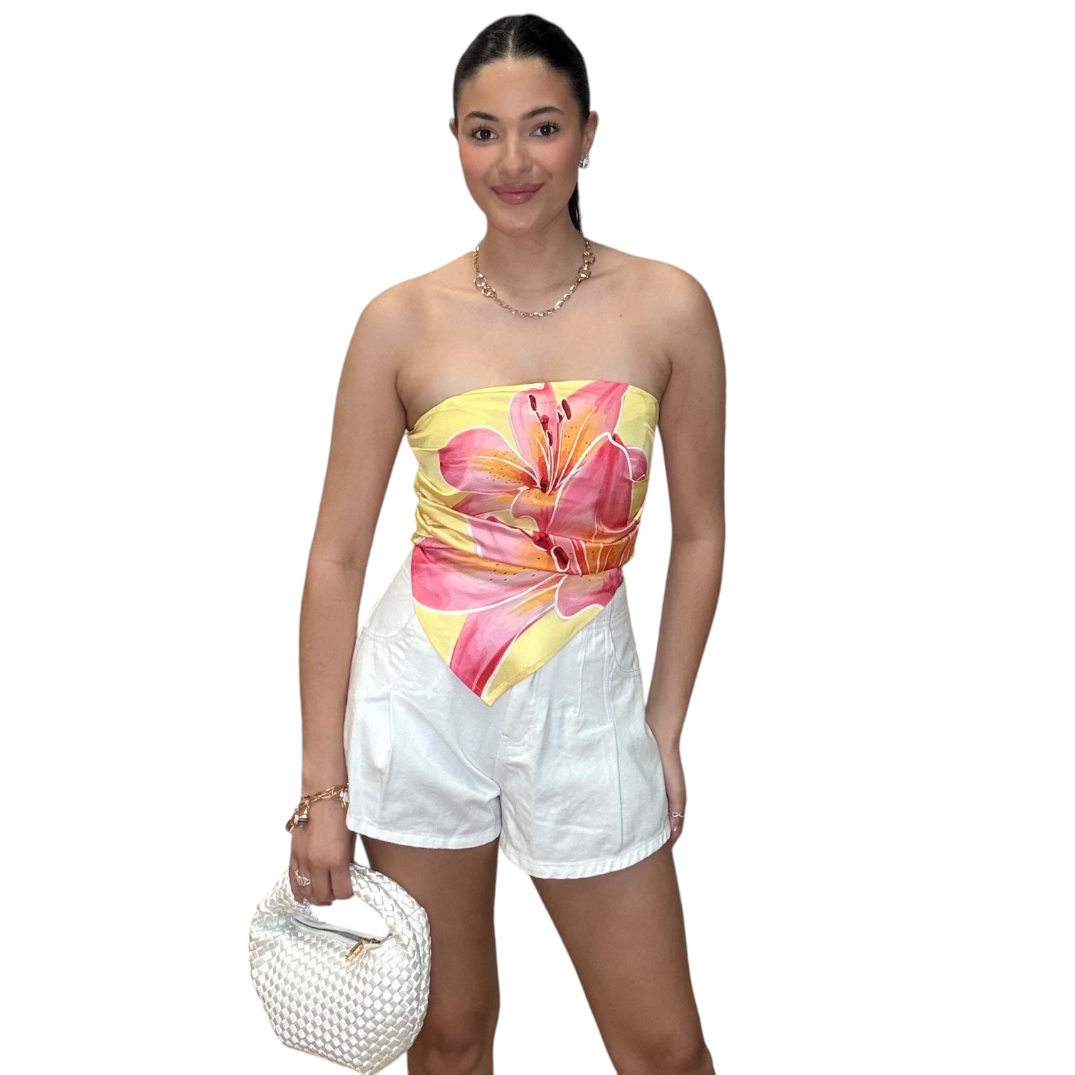 Strapless satin scarf top in pink floral design, paired with white shorts and a stylish bag.