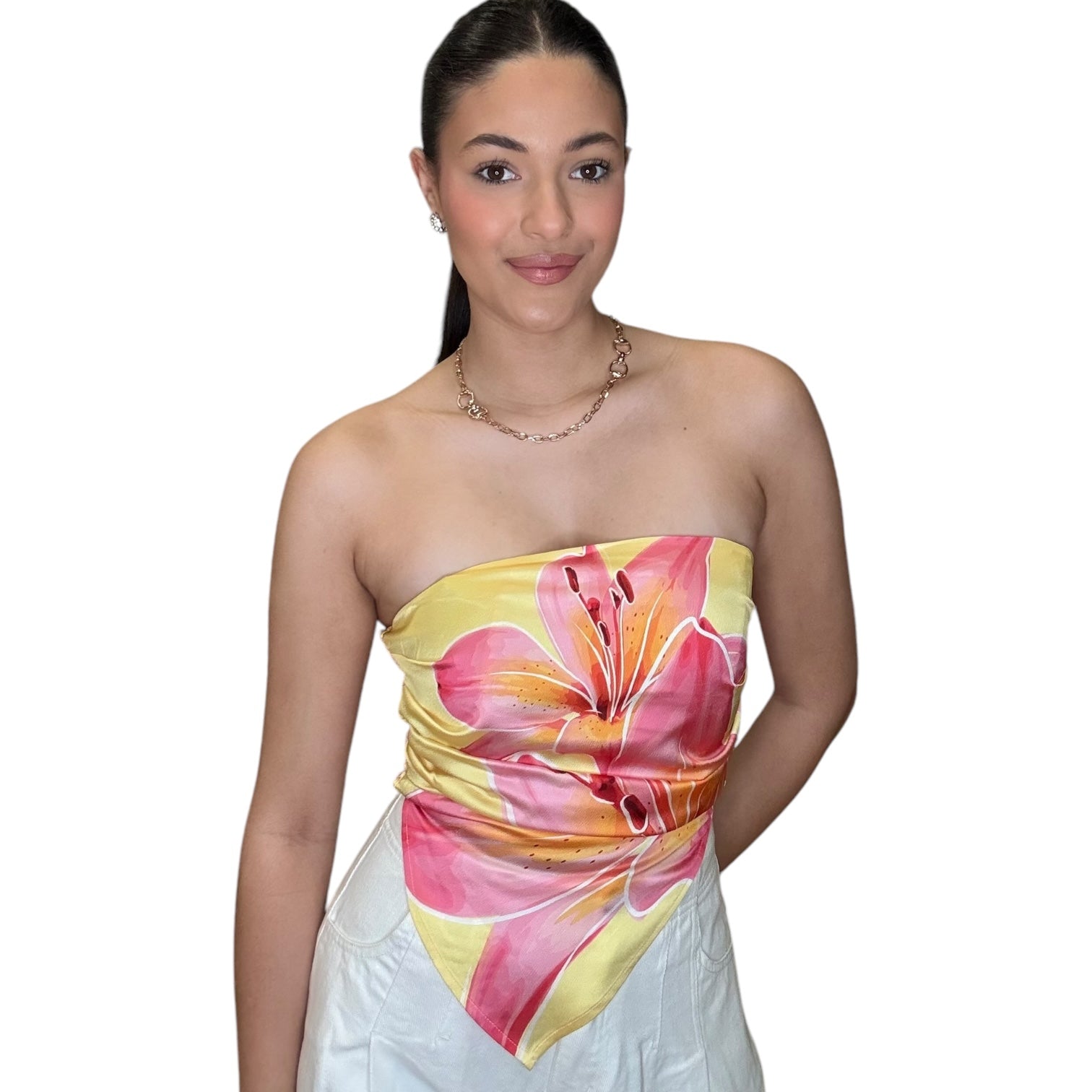 Model wearing a strapless satin scarf top in pink floral design, showcasing an elegant and stylish look.