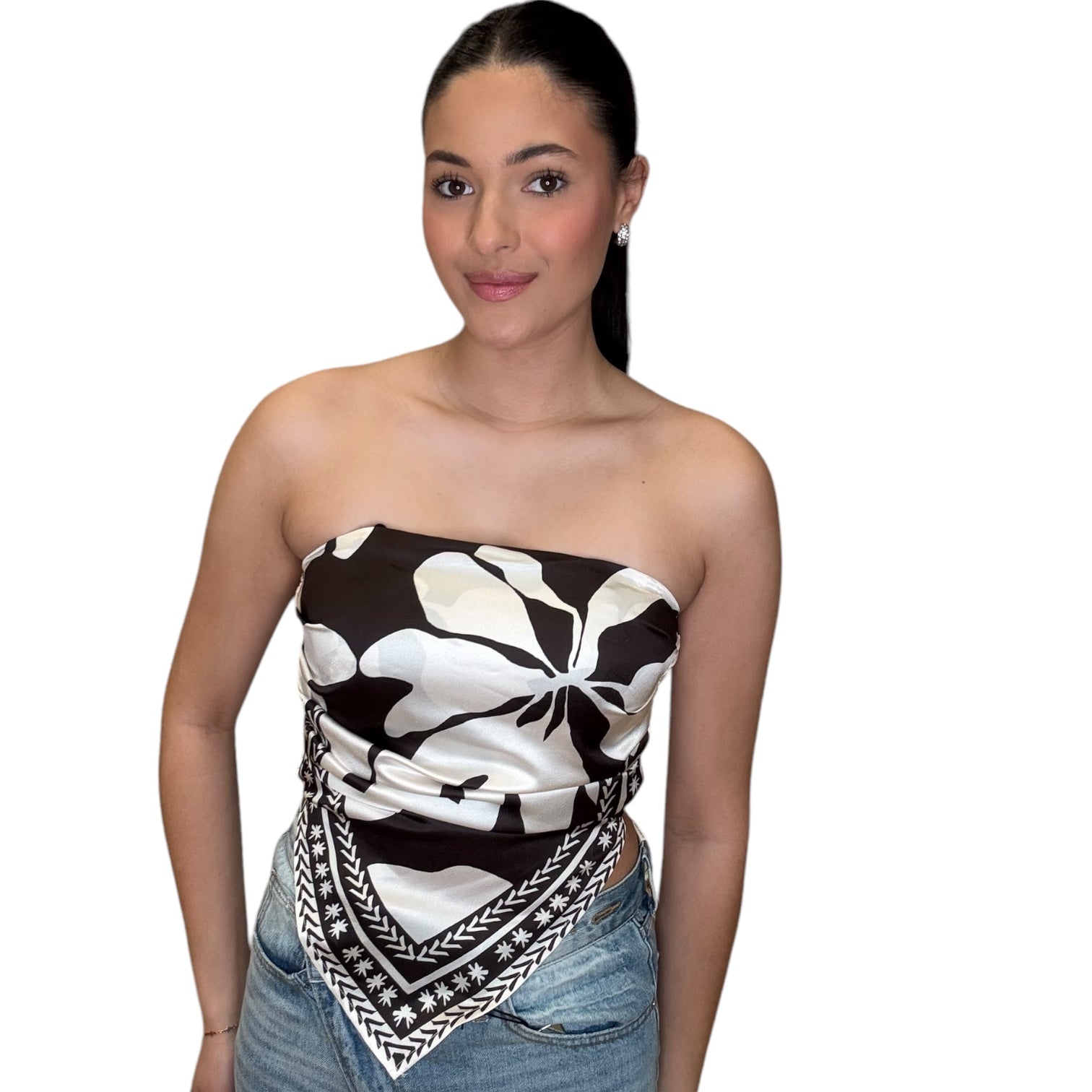 Young woman wearing a strapless satin scarf top in chocolate, showcasing its elegant design and floral print.