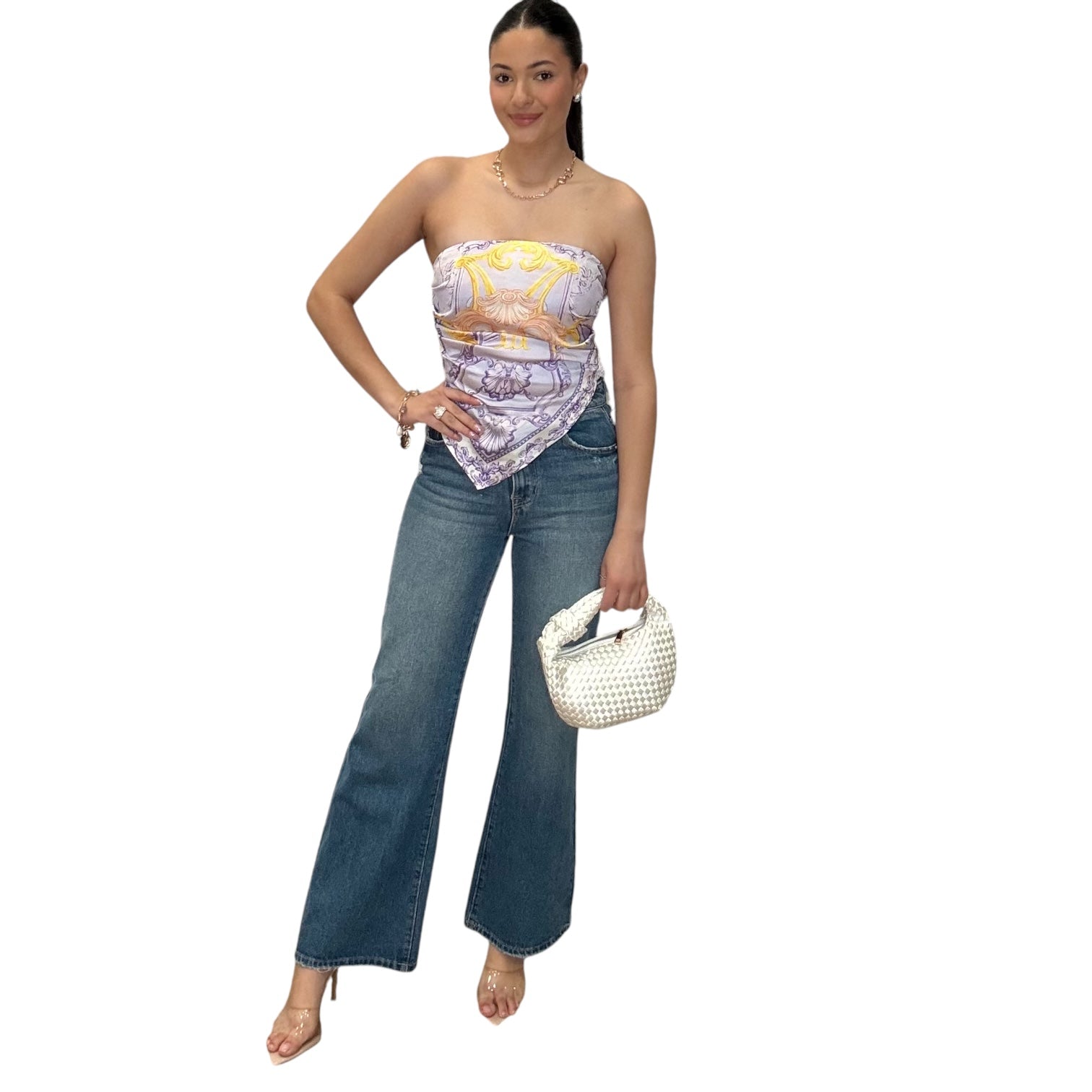 Strapless satin scarf top in lilac styled with high rise bootcut jeans and a chic handbag.