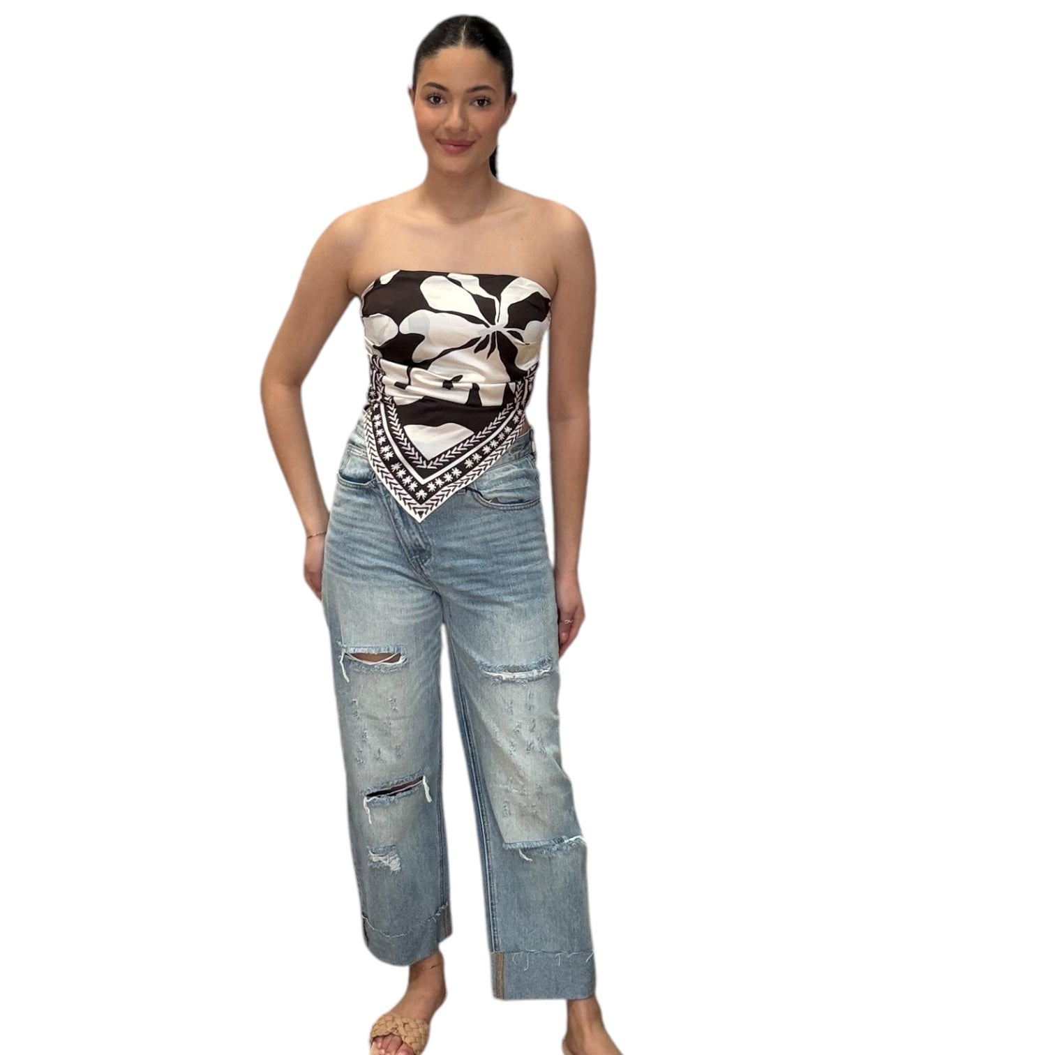 Model wearing strapless satin scarf top in chocolate with stylish ripped jeans for a chic casual look.