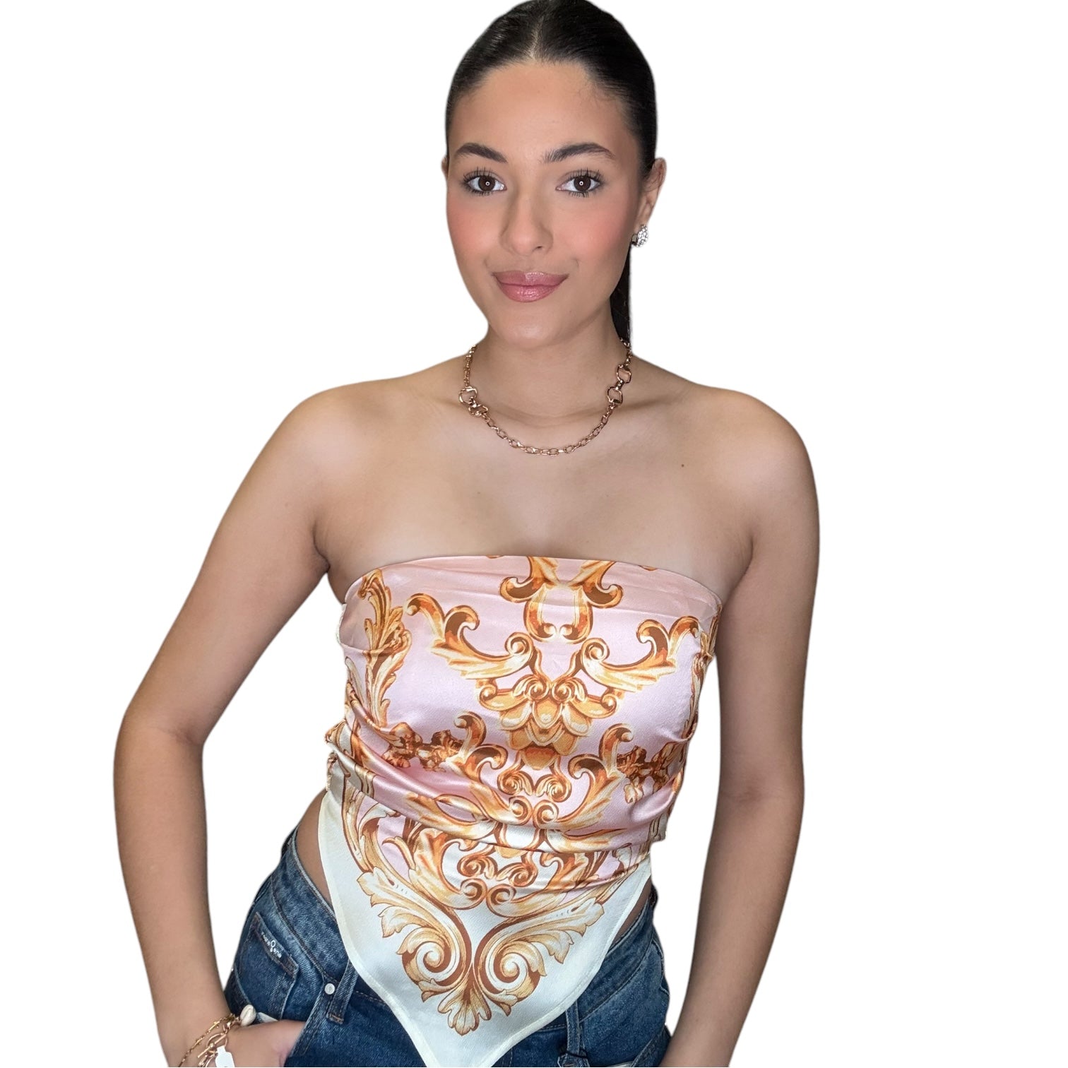 Strapless satin scarf top in pink with elegant print, styled with high rise jeans for a chic look.